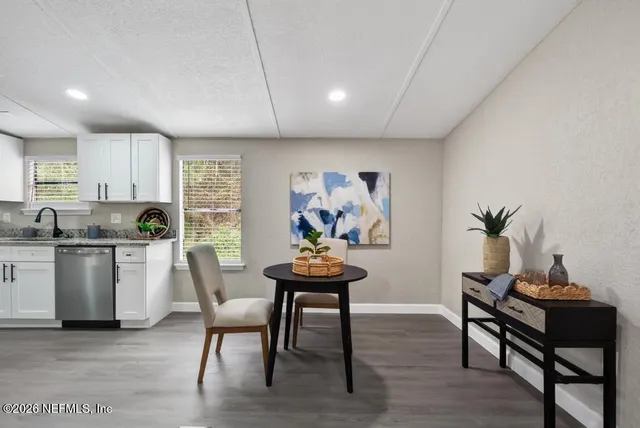a bathroom with a double vanity sink toilet mirror and bathtub