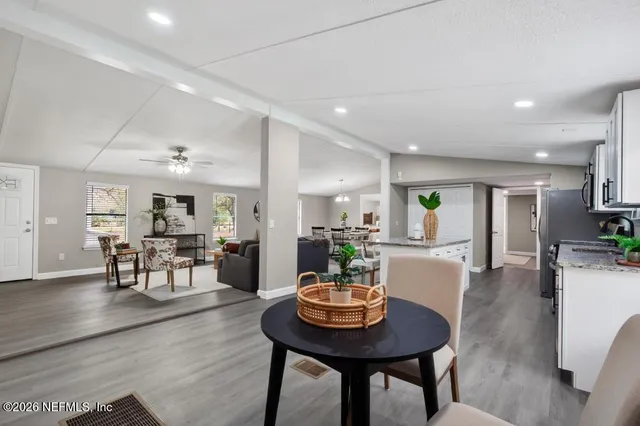 a view of a chair and table in backyard of the house