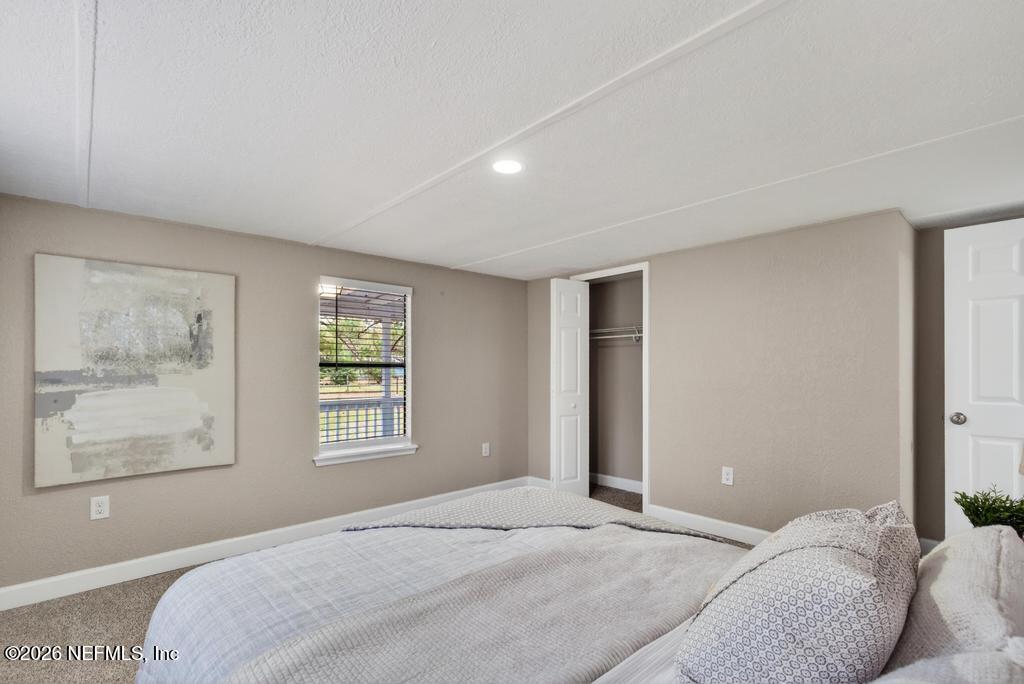 95422 Plum Loop Fernandina Beach, FL 32034 - Photo 44 of 84 a bedroom with a bed and wooden floor