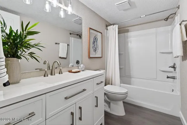 a view of a house with yard and tree s