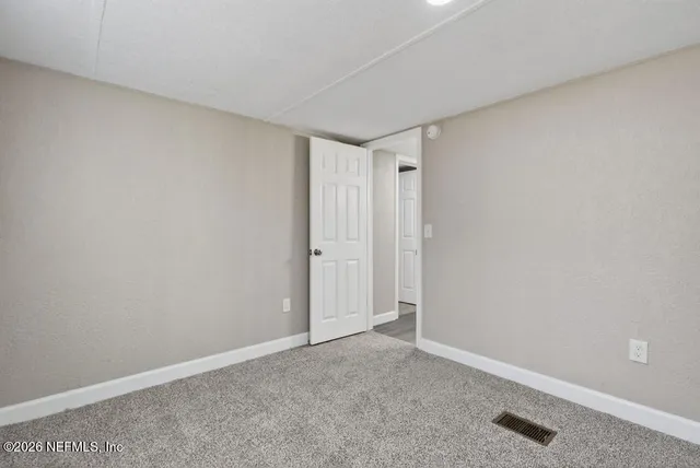 a view of a house with backyard and a tree