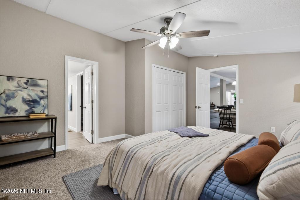 95422 Plum Loop Fernandina Beach, FL 32034 - Photo 56 of 84 a bedroom with a bed and a chandelier