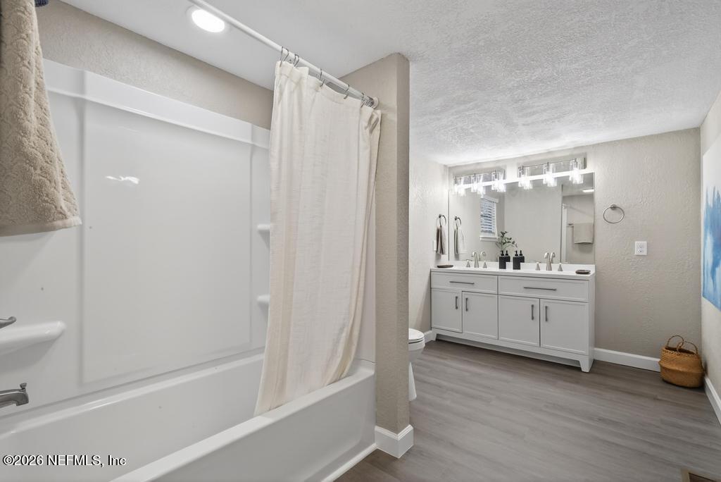 95422 Plum Loop Fernandina Beach, FL 32034 - Photo 57 of 84 a bathroom with a double vanity sink toilet mirror and bathtub
