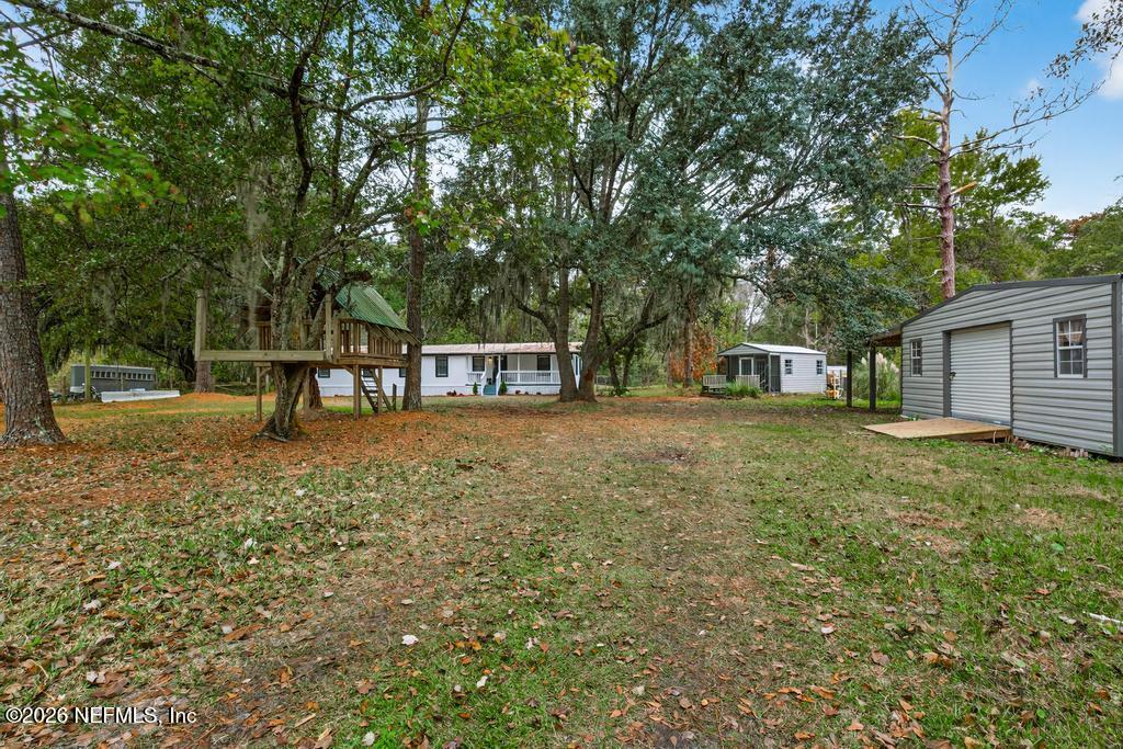 95422 Plum Loop Fernandina Beach, FL 32034 - Photo 80 of 84 a view of a house with backyard and a tree
