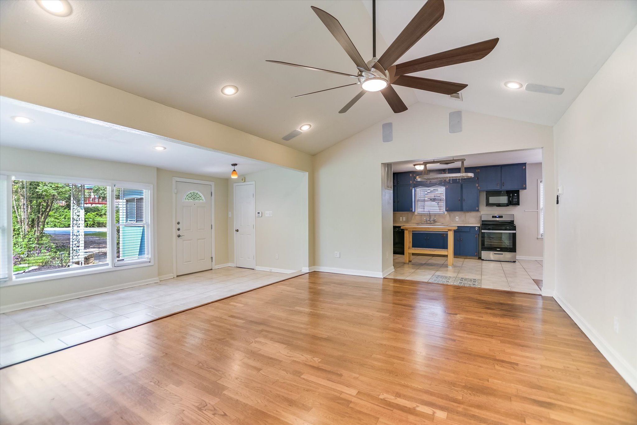 208 Braeswood Road Austin, TX 78704 - Photo 5 of 20 Hardwood flooring extends throughout this generous living area, openly flowing into the bright kitchen space.