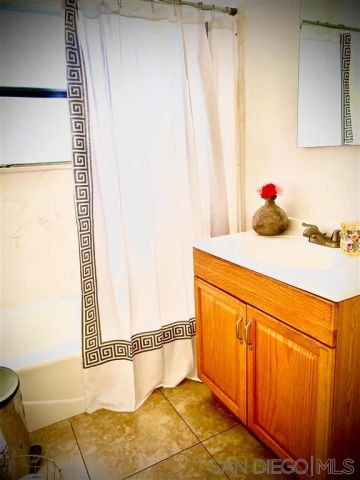 a bathroom with a shower curtain and a sink