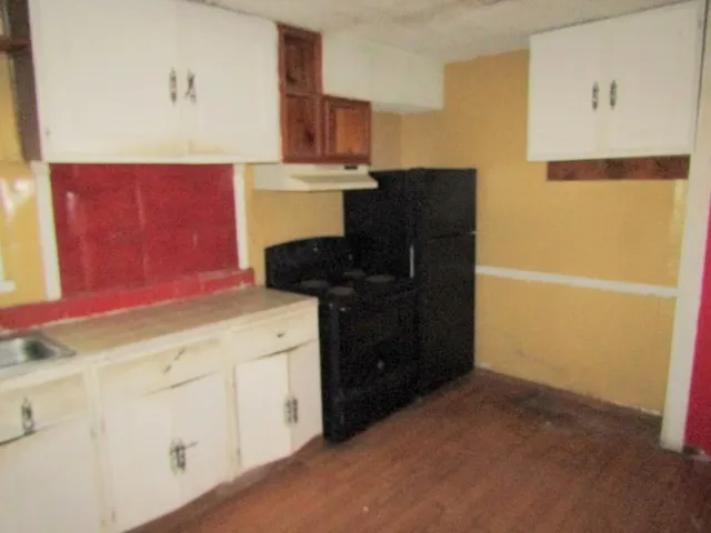 a kitchen with a refrigerator and a stove
