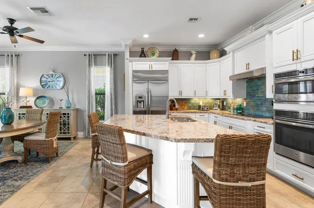 a kitchen with stainless steel appliances granite countertop a stove and a refrigerator