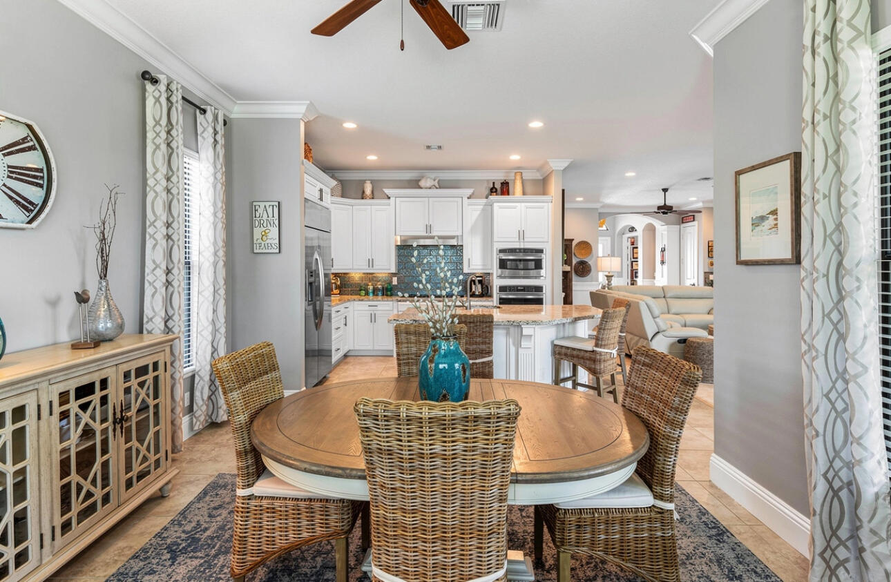 183 Calmo Circle Port St. Lucie, FL 34984 - Photo 15 of 38 a dining room with furniture a rug and wooden floor