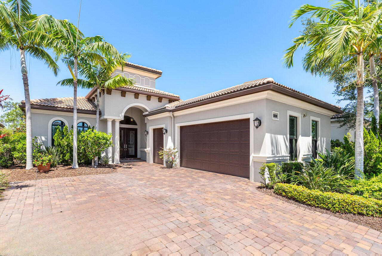183 Calmo Circle Port St. Lucie, FL 34984 - Photo 2 of 38 a front view of a house with garden