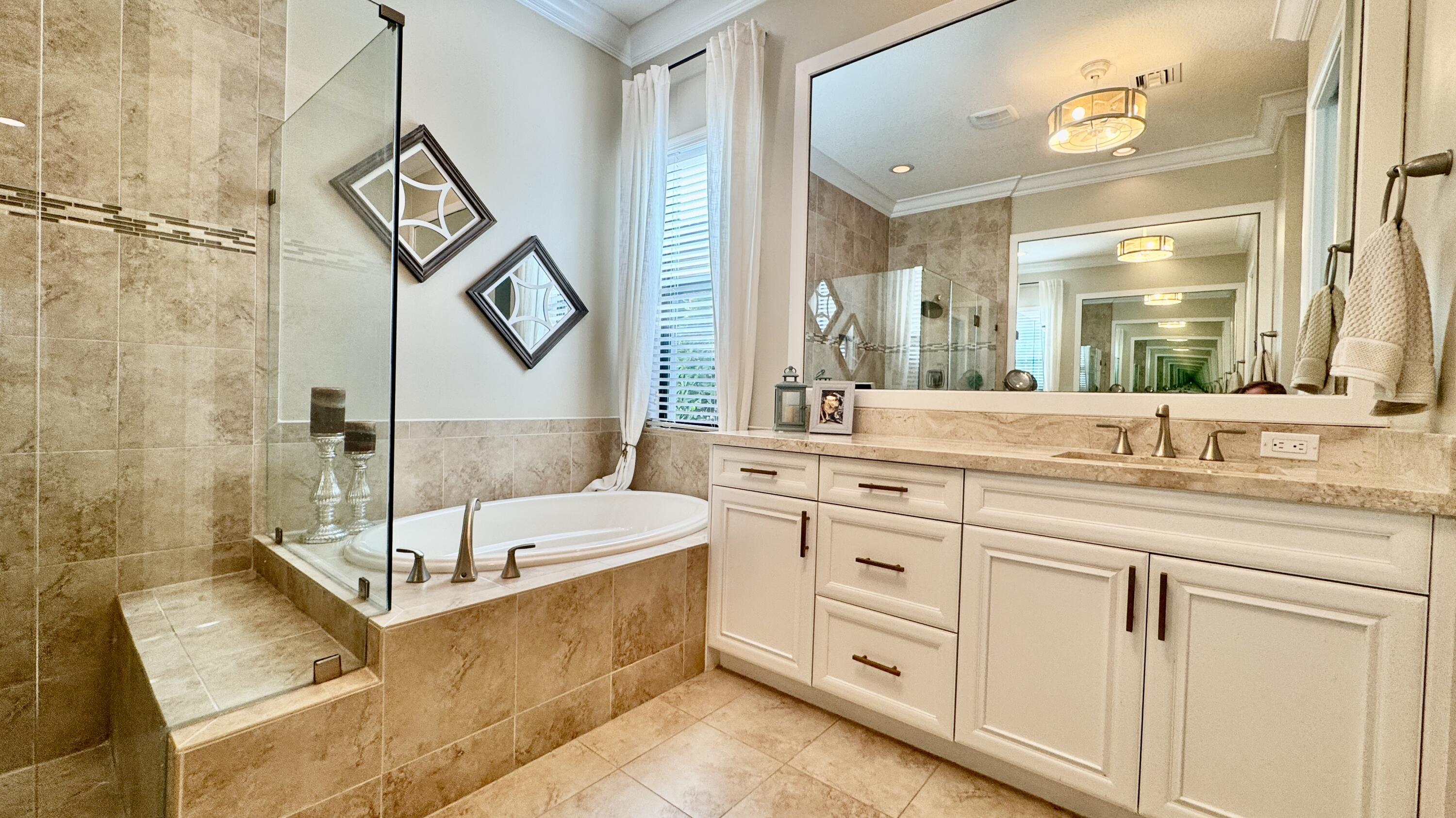 183 Calmo Circle Port St. Lucie, FL 34984 - Photo 21 of 38 a bathroom with a double vanity sink mirror and bathtub