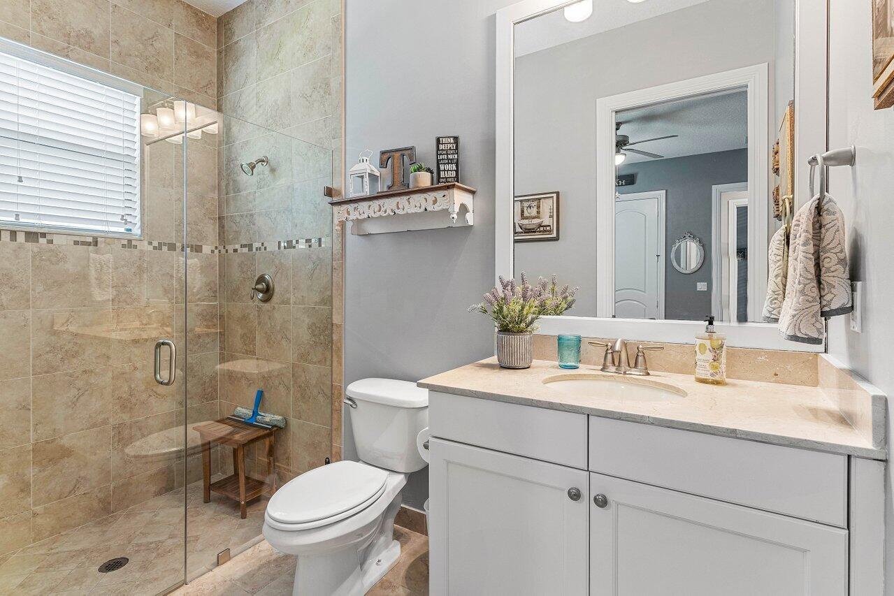 183 Calmo Circle Port St. Lucie, FL 34984 - Photo 24 of 38 a bathroom with a sink toilet and shower