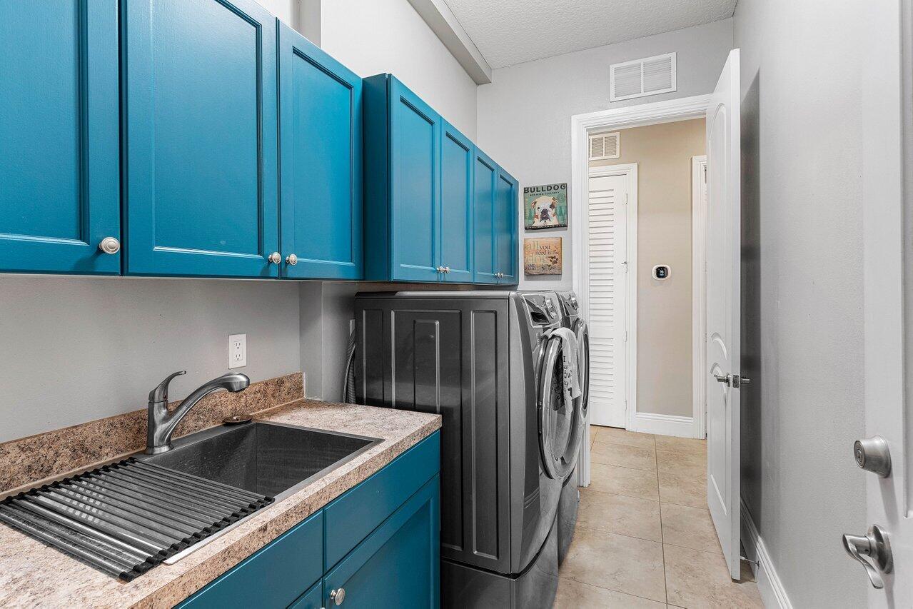 183 Calmo Circle Port St. Lucie, FL 34984 - Photo 25 of 38 a kitchen with a sink and refrigerator