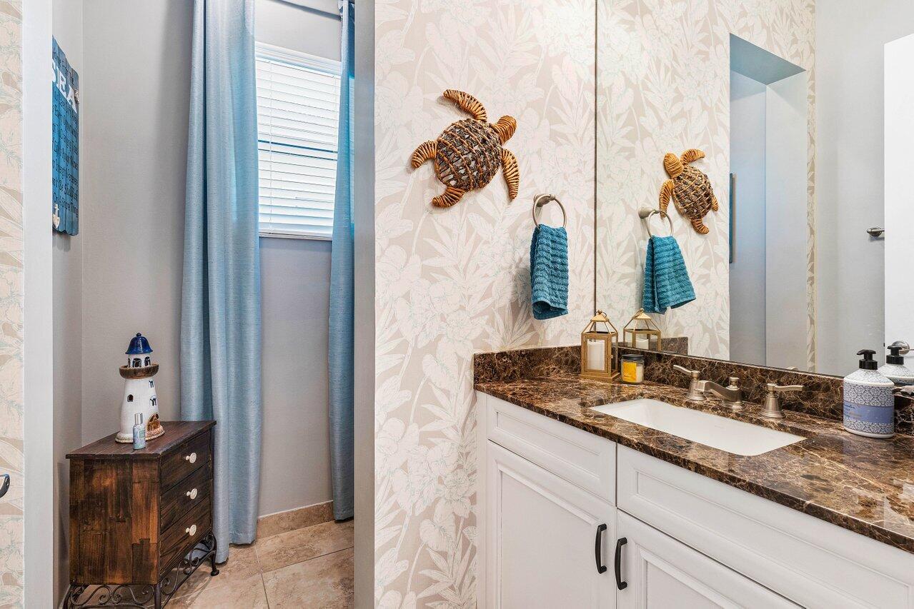 183 Calmo Circle Port St. Lucie, FL 34984 - Photo 26 of 38 a bathroom with a granite countertop sink and a mirror