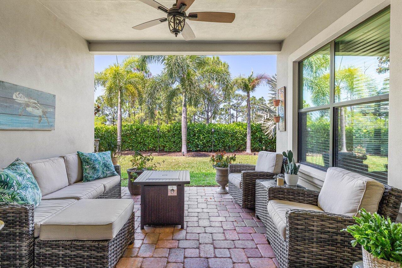 183 Calmo Circle Port St. Lucie, FL 34984 - Photo 30 of 38 a living room with patio furniture and a floor to ceiling window