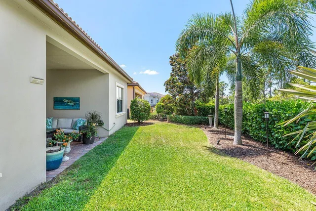 a view of a backyard with table and chairs and potted plants