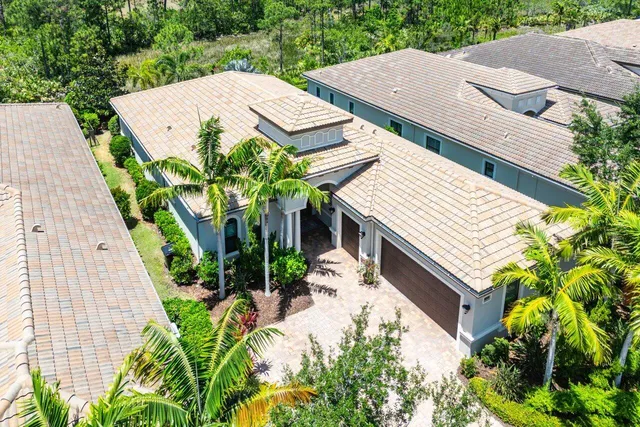 an aerial view of a house with a yard and potted plants