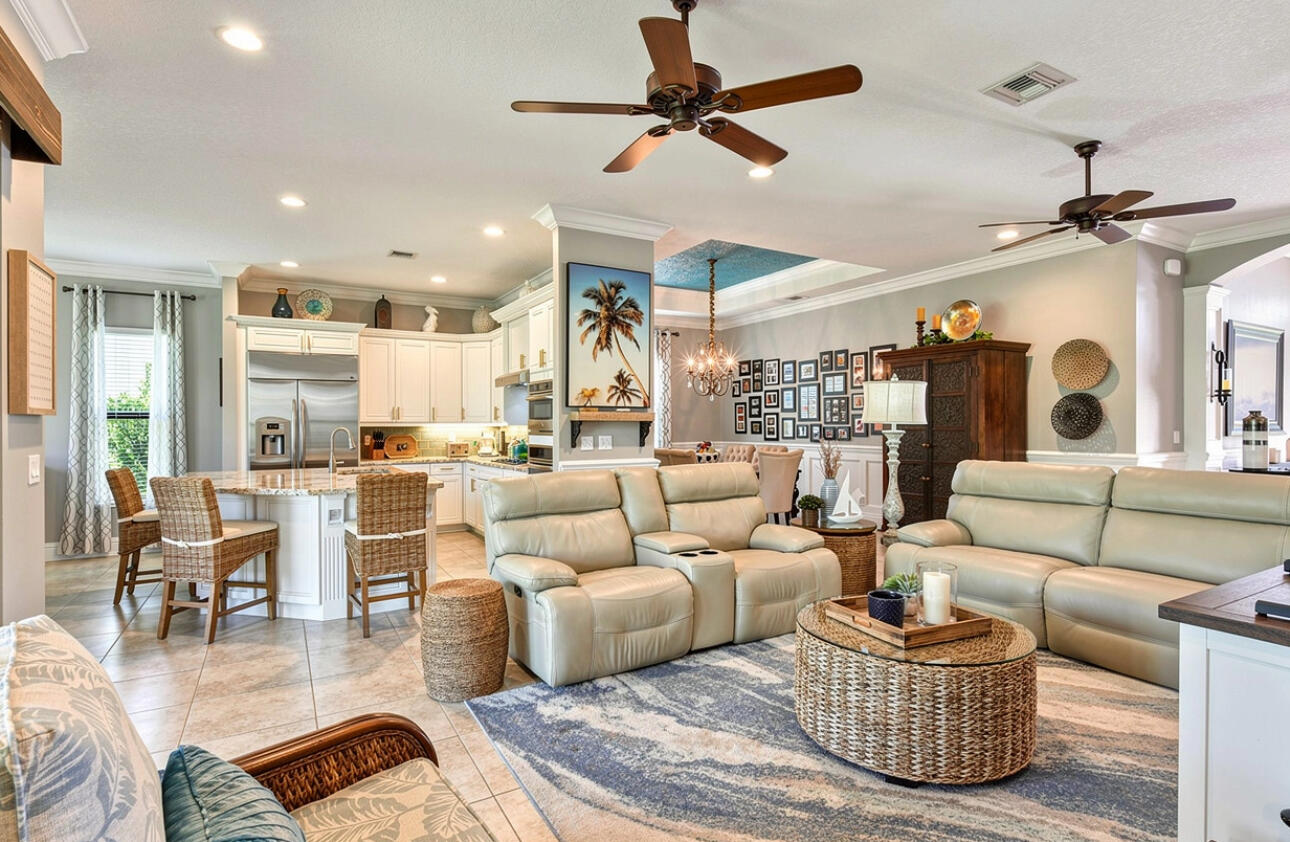 183 Calmo Circle Port St. Lucie, FL 34984 - Photo 6 of 38 a living room with furniture kitchen view and a chandelier
