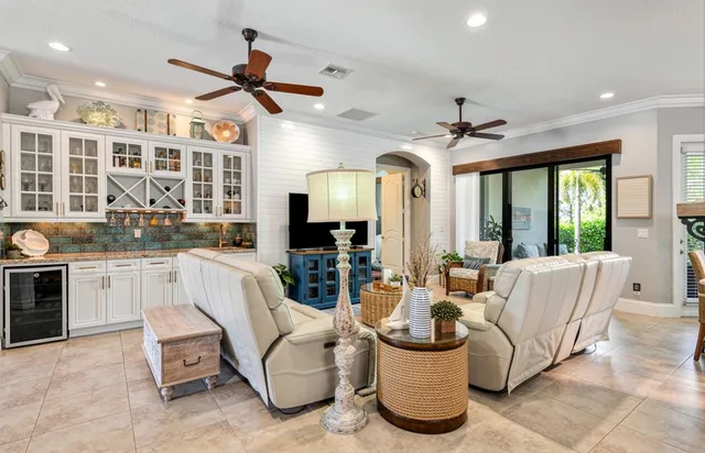 a living room with furniture a chandelier and a fireplace