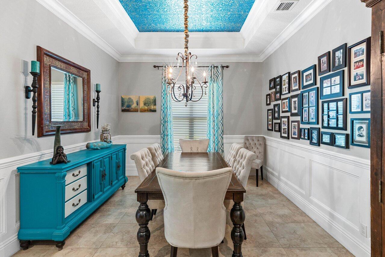 183 Calmo Circle Port St. Lucie, FL 34984 - Photo 8 of 38 a dining room with furniture a chandelier and window