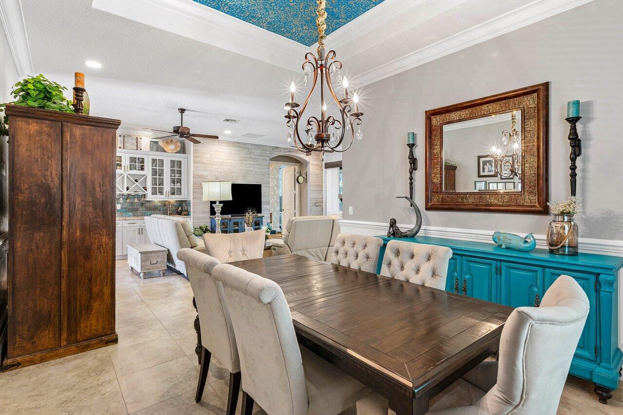183 Calmo Circle Port St. Lucie, FL 34984 - Photo 9 of 38 a view of a dining room with furniture window and wooden floor