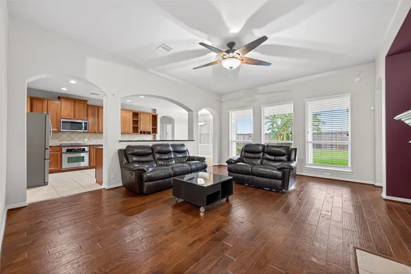 a living room with furniture and wooden floor