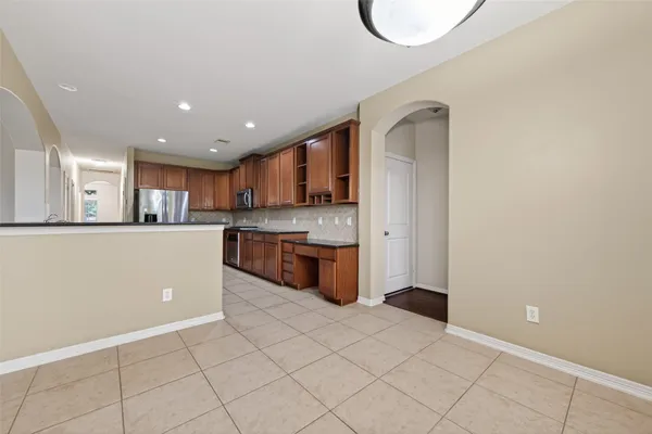 a kitchen with stainless steel appliances granite countertop a refrigerator sink and cabinets