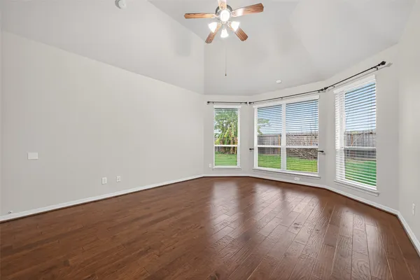 a view of wooden floor and windows in a room