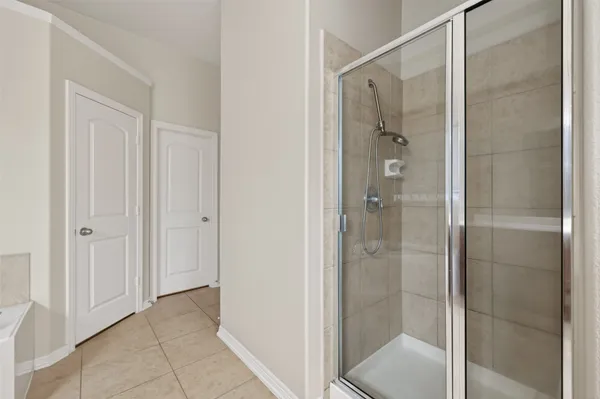 a bathroom with a glass shower door