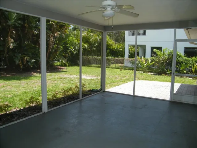 a view of an empty room with a floor to ceiling window and a table