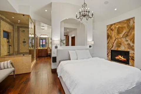 a spacious bedroom with a bed and a fireplace