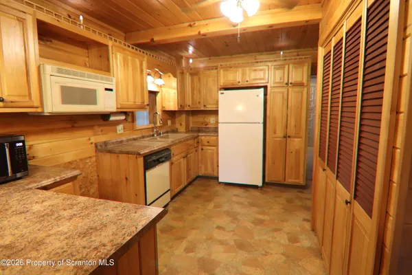 a kitchen with stainless steel appliances granite countertop a stove a refrigerator and a sink