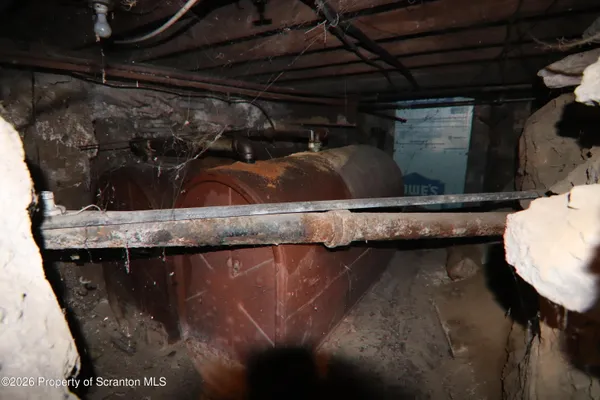 a view of an empty room with a fireplace and a window