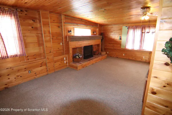 a living room with a fireplace and a flat screen tv