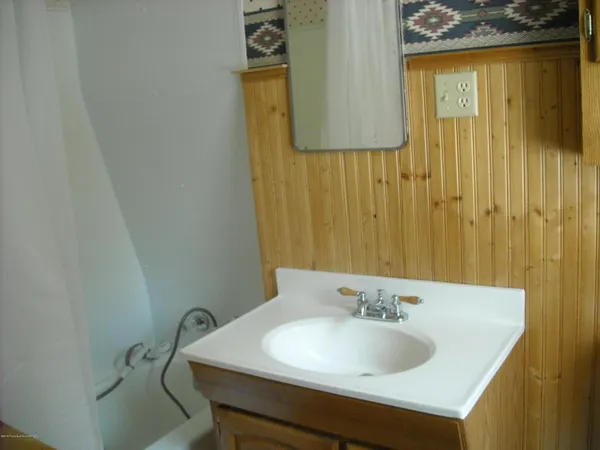 a bathroom with a sink bathtub and a window