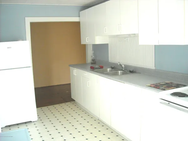 a view of a livingroom with a ceiling fan and window