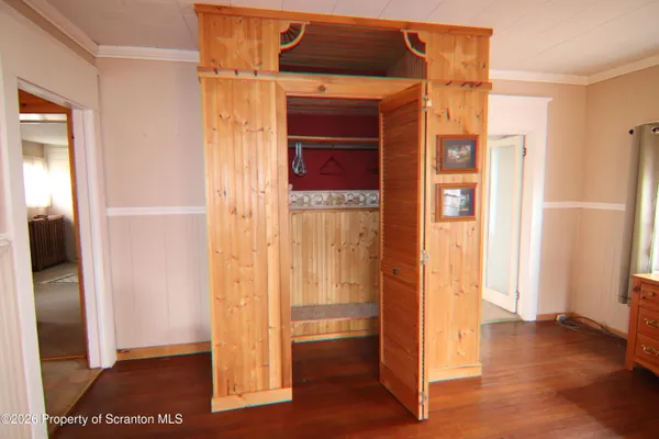 a view of walk in closet with empty room