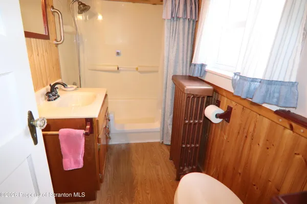 a bathroom with a sink toilet and mirror