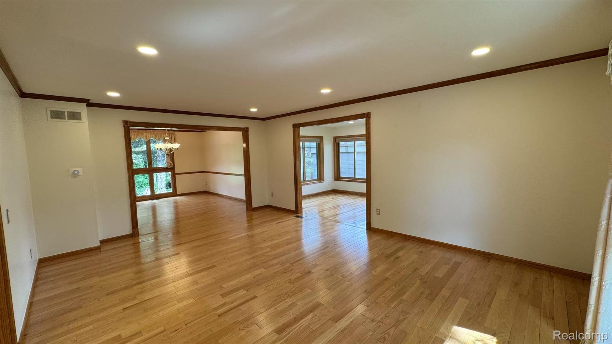 3440 Salem Drive Rochester, MI 48306 - Photo 5 of 33 Expansive interior space featuring wood-finish flooring, recessed lighting, and white walls with contrasting dark trim