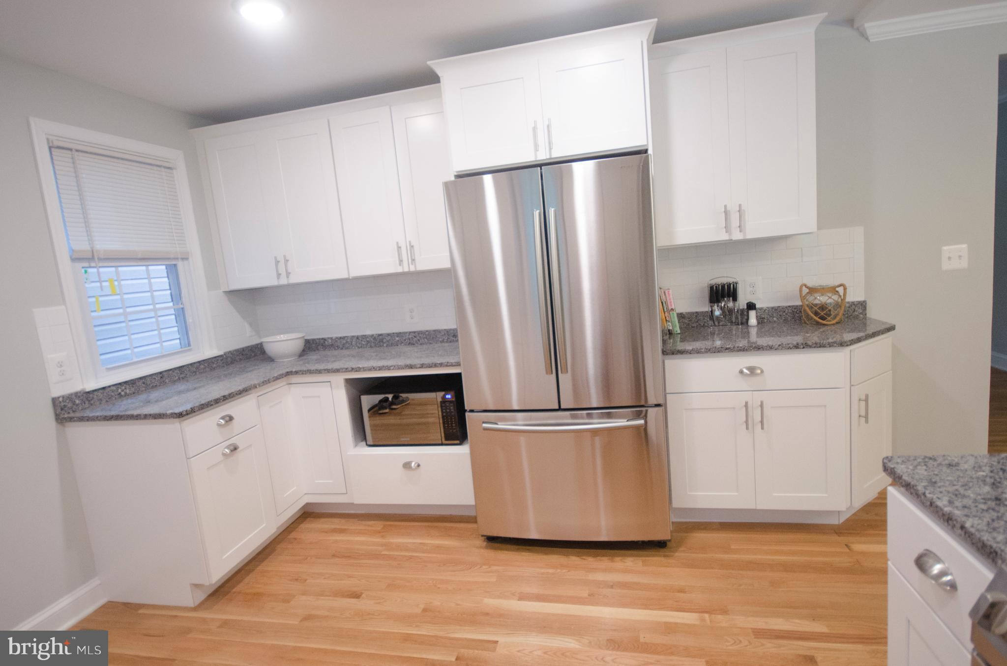1007 Roxleigh Road Baltimore, MD 21286 - Photo 8 of 29 a kitchen with white cabinets and stainless steel appliances