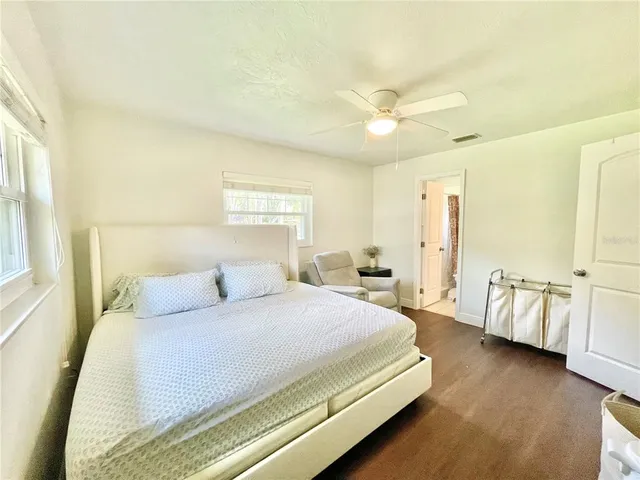 a bedroom with a large bed and a chandelier