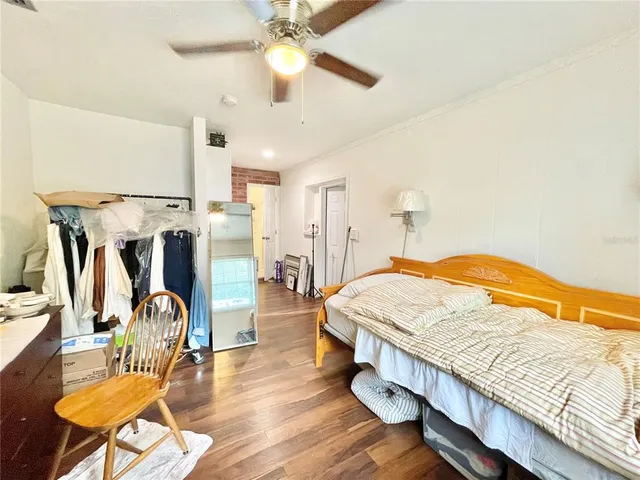 a spacious bedroom with a bed and a chandelier