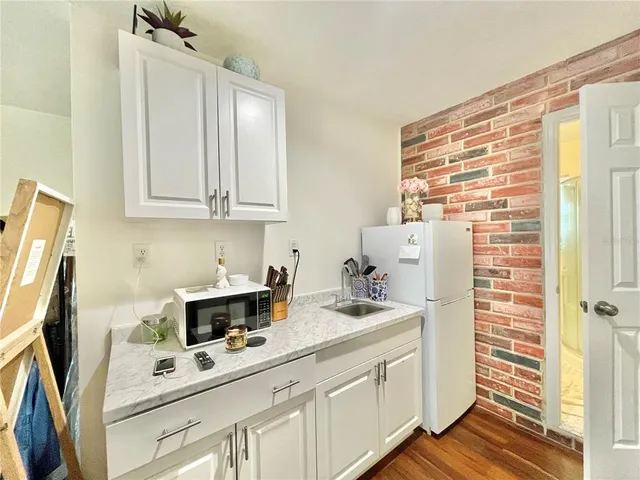 a kitchen with stainless steel appliances a refrigerator sink and cabinets