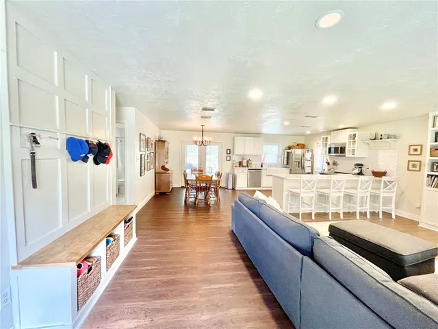 a dining hall with stainless steel appliances kitchen island granite countertop a refrigerator and a counter top space