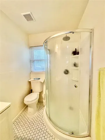 a bathroom with a shower toilet and sink