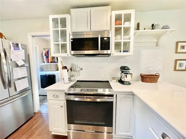 a kitchen with granite countertop a sink and a stove top oven