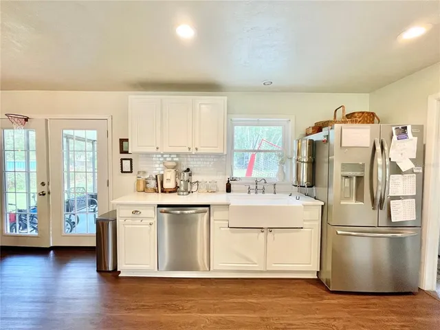 a kitchen with stainless steel appliances a stove a refrigerator and cabinets