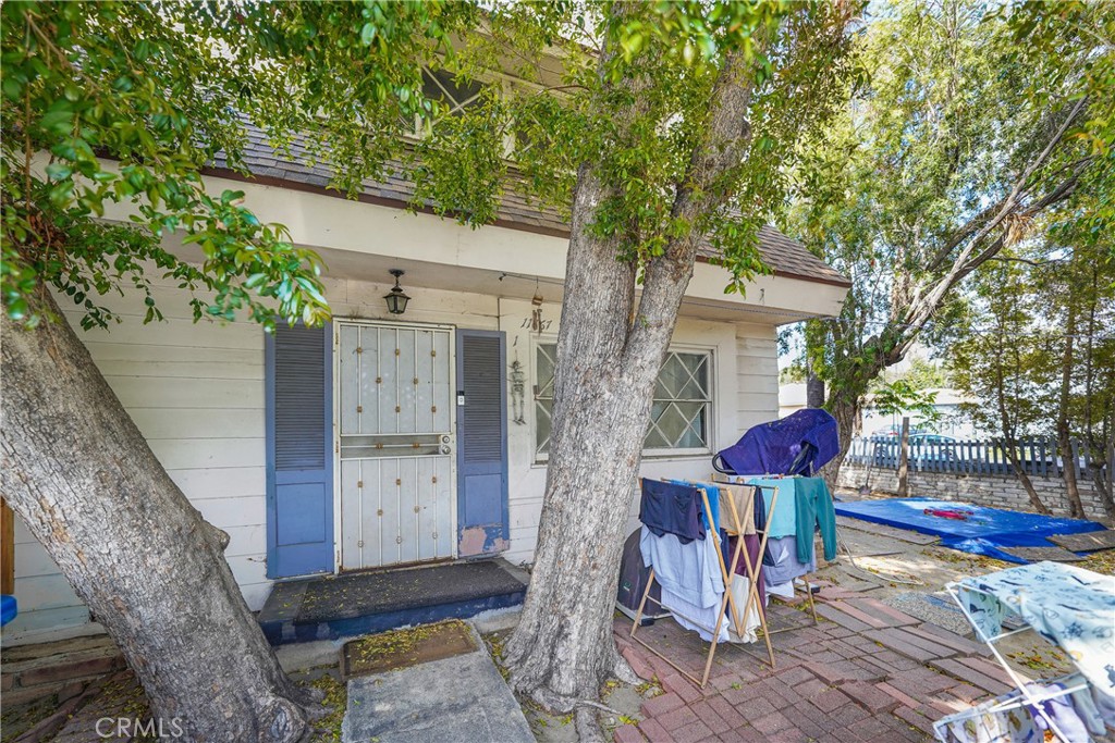11667 Burbank Boulevard North Hollywood, CA 91601 - Photo 13 of 15 a front view of a house with a tree