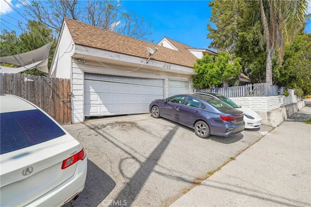 a car parked in front of white house