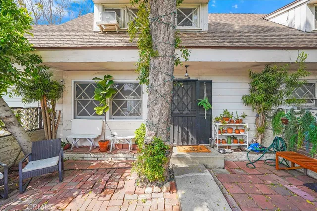 a front view of a house with outdoor seating